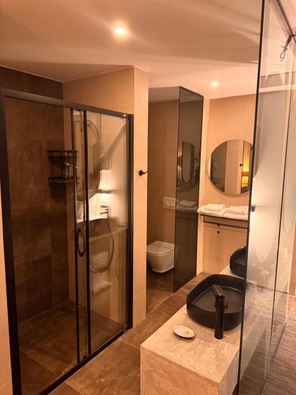 Bathroom with walk-in shower at Hotel Pljevlja